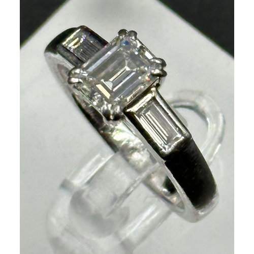 555A - Diamond ring with centrally set emerald cut diamond, approx 6.48mm x 5.03mm x 3.34mm, stated weight ... 