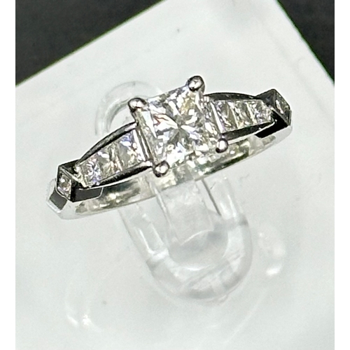 555C - A diamond single stone ring with diamond set shoulders and mount. Princess cut diamond, measuring 5.... 