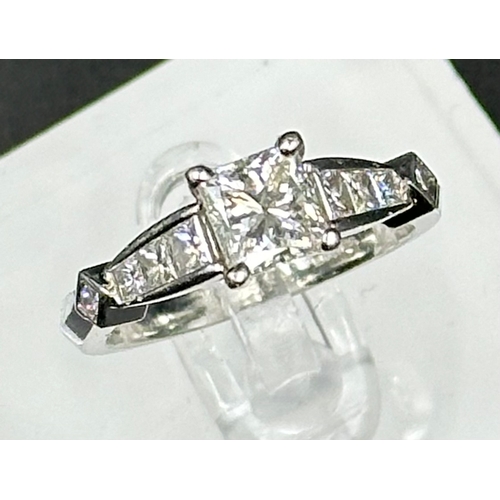 555C - A diamond single stone ring with diamond set shoulders and mount. Princess cut diamond, measuring 5.... 