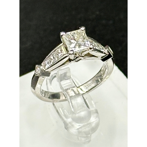 555C - A diamond single stone ring with diamond set shoulders and mount. Princess cut diamond, measuring 5.... 