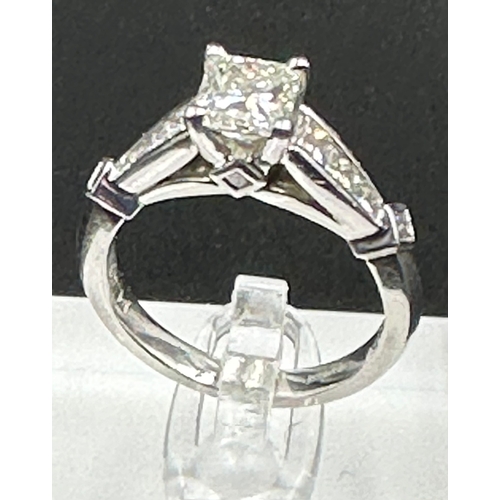 555C - A diamond single stone ring with diamond set shoulders and mount. Princess cut diamond, measuring 5.... 