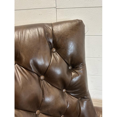 101 - A brown leather button backed wing arm chair by Henredon leather company with brass studs and castor... 