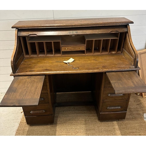 105 - An Edwardian oak roll top desk comprising of six drawers, storage compartments and original key (H11... 