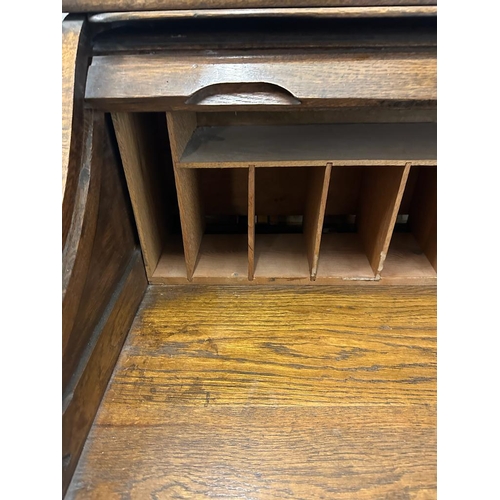 105 - An Edwardian oak roll top desk comprising of six drawers, storage compartments and original key (H11... 