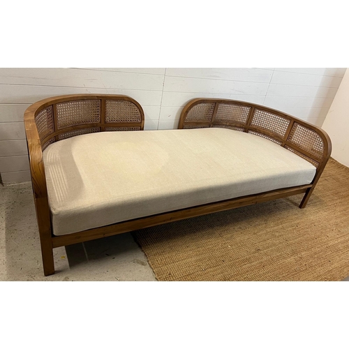 114 - A Nest daybed with teak curved frame and cane sides (H69cm W212cm D98cm)