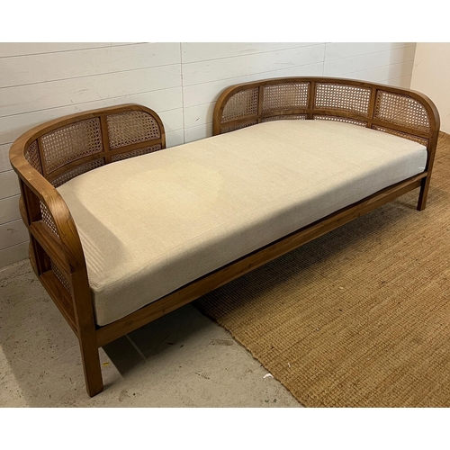 114 - A Nest daybed with teak curved frame and cane sides (H69cm W212cm D98cm)