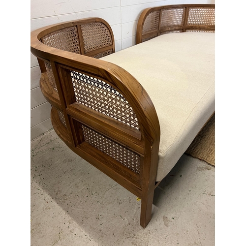 114 - A Nest daybed with teak curved frame and cane sides (H69cm W212cm D98cm)