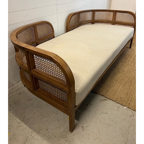 114 - A Nest daybed with teak curved frame and cane sides (H69cm W212cm D98cm)