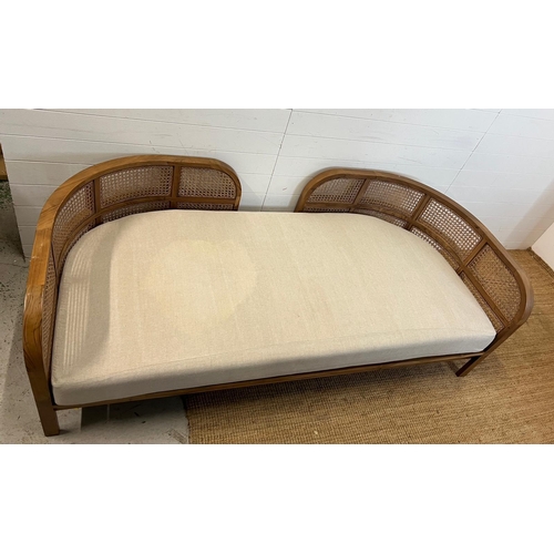 114 - A Nest daybed with teak curved frame and cane sides (H69cm W212cm D98cm)