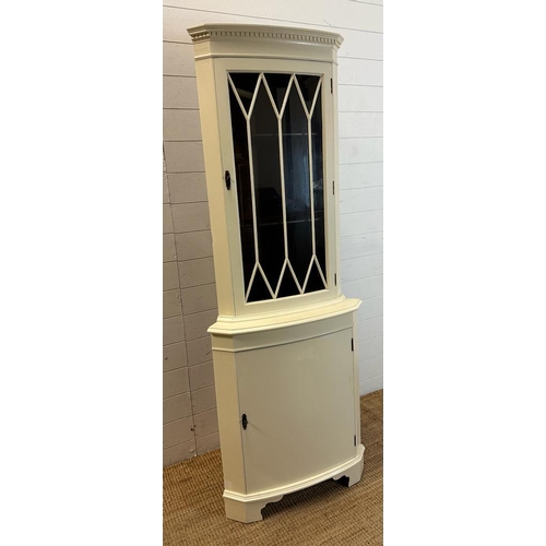 121 - A white painted glazed corner cabinet with cupboard under (H180cm W68cm D40cm)