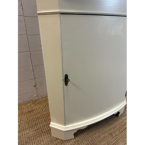 121 - A white painted glazed corner cabinet with cupboard under (H180cm W68cm D40cm)