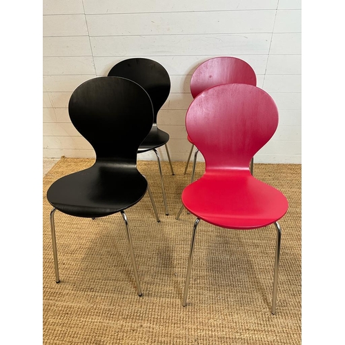 123 - Four butterfly back dining chairs on chrome legs with laminate finish, two red and two black