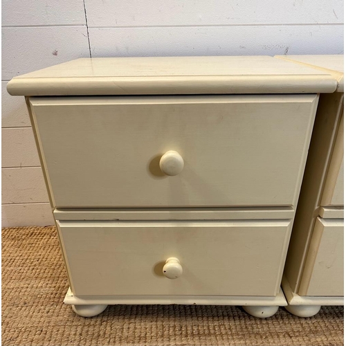 126 - A pair of white painted two drawer bedside tables on bun feet (H53cm W51cm D43cm)