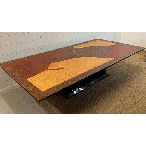 135 - A large and deco style mixed wood veneered coffee table (H93cm W200cm D10cm)