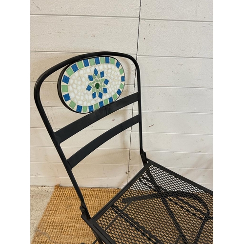 138 - Two black wrought iron garden chairs with tiled mosaic backs and a bistro table frame