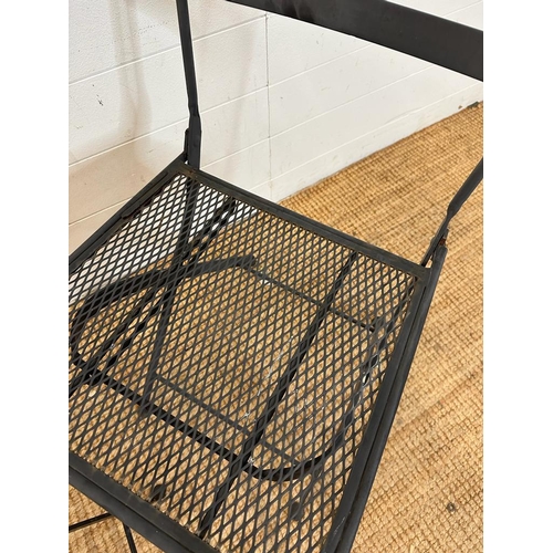 138 - Two black wrought iron garden chairs with tiled mosaic backs and a bistro table frame