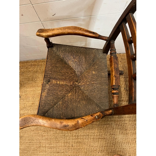 14 - An oak and rustic style rush seat rocking chair