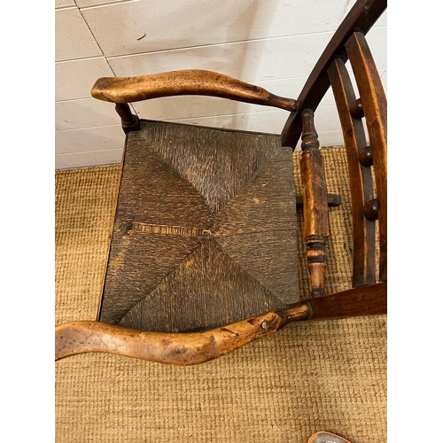 14 - An oak and rustic style rush seat rocking chair