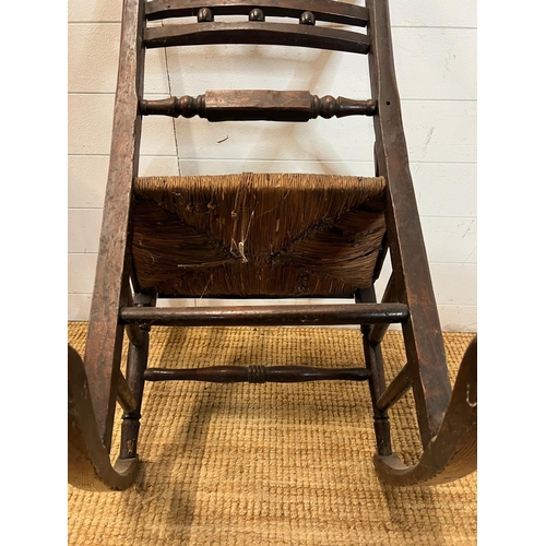 14 - An oak and rustic style rush seat rocking chair