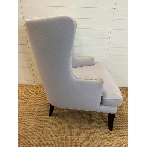 145 - A contemporary wing back arm chair, upholstered in lilac