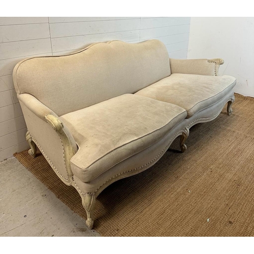 146 - A four seater Louis style sofa with white painted frame and studded beige upholstery (224cm x 112cm)