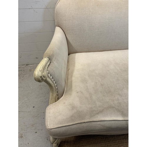 146 - A four seater Louis style sofa with white painted frame and studded beige upholstery (224cm x 112cm)