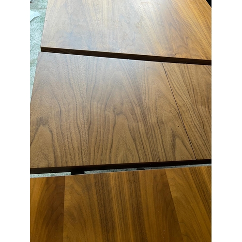 154 - An expanding dining table with brushed steel X frame legs