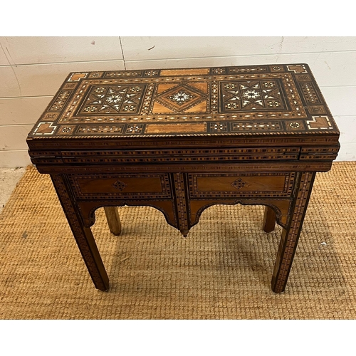 16 - A marquetry inlaid games table with playing surface, back gammon, chess board etc , Damasais or Syri... 