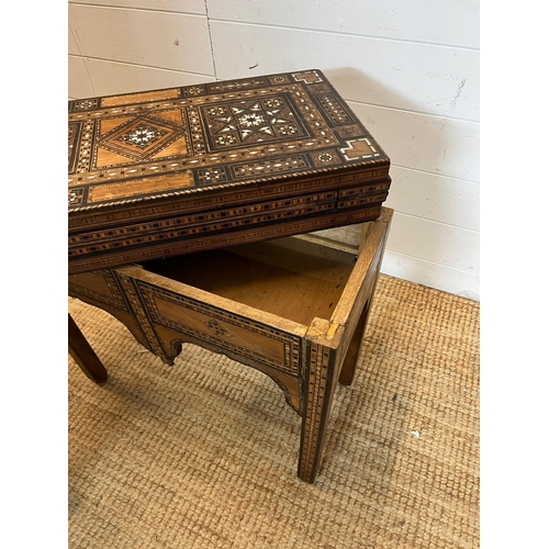 16 - A marquetry inlaid games table with playing surface, back gammon, chess board etc , Damasais or Syri... 