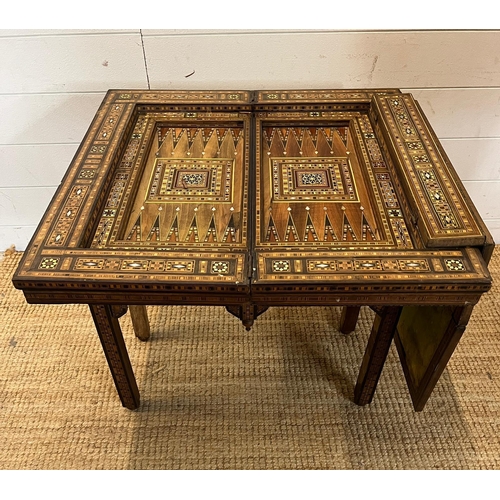 16 - A marquetry inlaid games table with playing surface, back gammon, chess board etc , Damasais or Syri... 