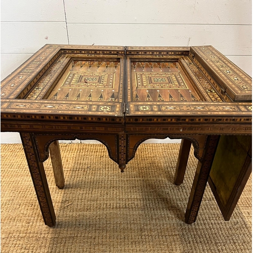 16 - A marquetry inlaid games table with playing surface, back gammon, chess board etc , Damasais or Syri... 