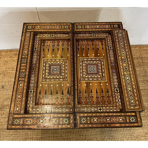 16 - A marquetry inlaid games table with playing surface, back gammon, chess board etc , Damasais or Syri... 