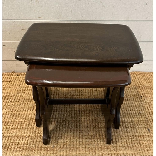 162 - A nest of two stained oak Mid Century side tables (H39cm W45cm D30cm)