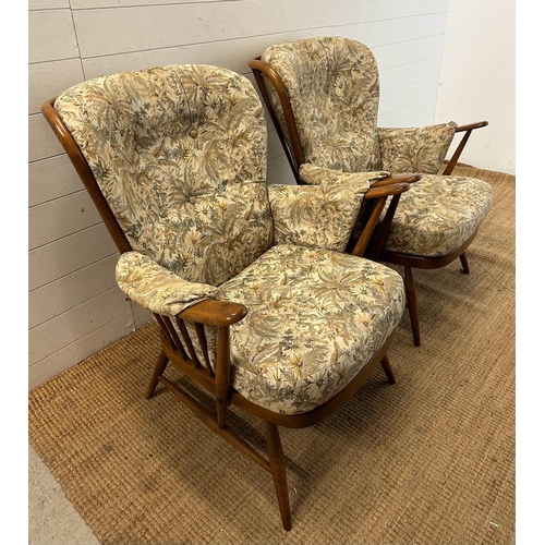 165 - A pair of Ercol Evergreen Easy chairs with button back floral upholstery