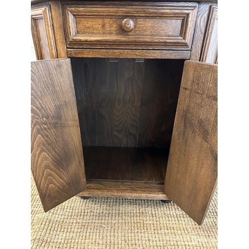 168 - An oak two door panelled side cabinet with single drawer over (H79cm W67cm D30cm)