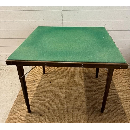 174 - A folding games table with green baize top (83cm x 83cm)