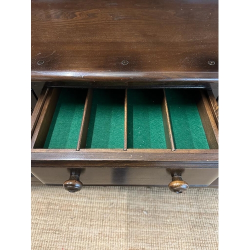 181 - A dark Ercol dresser comprising of four drawer flanked by cupboards and a two tier plate rack over (... 