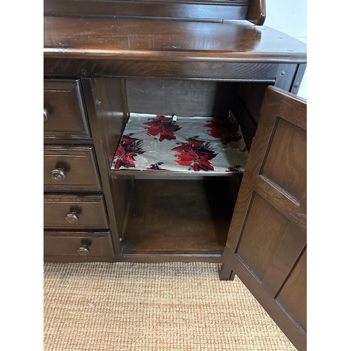 181 - A dark Ercol dresser comprising of four drawer flanked by cupboards and a two tier plate rack over (... 