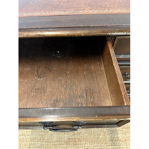 187 - A pedestal desk with brown leather top, a central long drawer flanked on either side by four short d... 