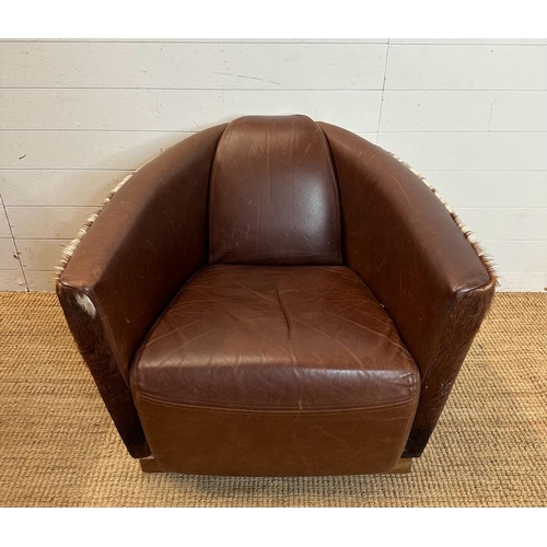 2 - Two cow hide backed brown tub chairs