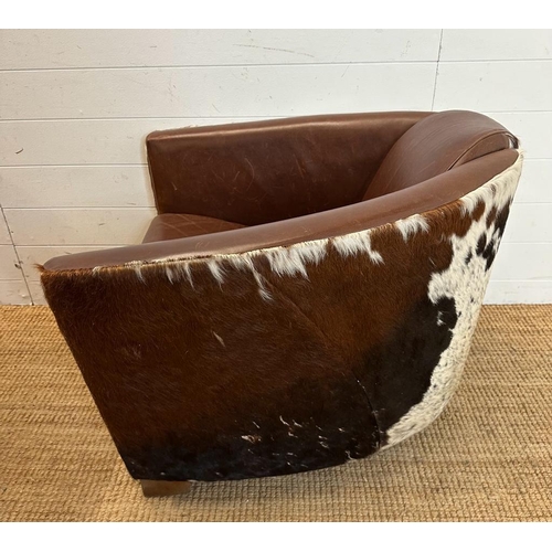 2 - Two cow hide backed brown tub chairs