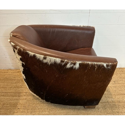 2 - Two cow hide backed brown tub chairs