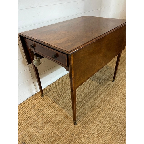 20 - A drop sided Pembroke table on tapering legs and drawers (H72cm W106cm D81cm