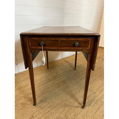 20 - A drop sided Pembroke table on tapering legs and drawers (H72cm W106cm D81cm