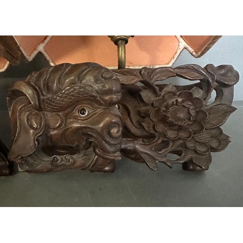 202 - A pair of Chinese hardwood wall sconces in the form of elephants