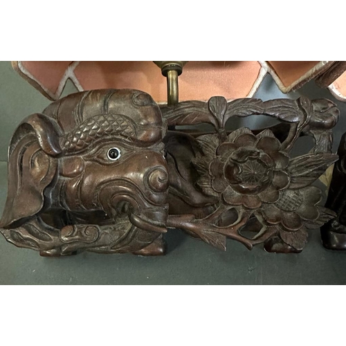 202 - A pair of Chinese hardwood wall sconces in the form of elephants