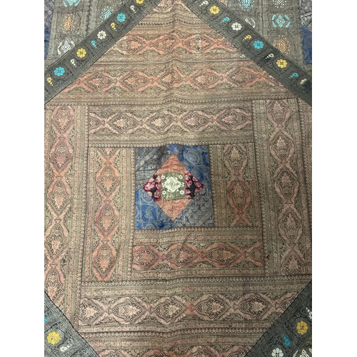 212 - A Persian embroidered textile in cottons and silks 265cm x 224cm