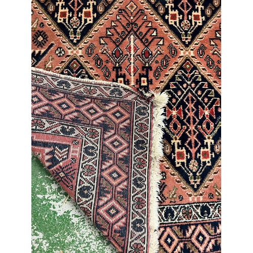 214 - A Persian style rug with geometric pattern 170cm x 142cm