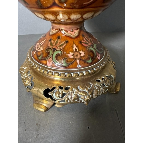 217 - A Victorian oil lamp by Williams And Bach of London. The central floraly painted bowl sitting on bra... 