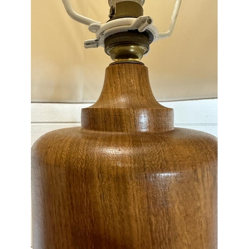 230 - An oak turned table lamp with brass banding